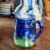 Charmant Vlaams melkkannetje in levendig blauw‑groen aardewerk | Charming Flemish blue‑green glazed milk jug – vintage earthenware
